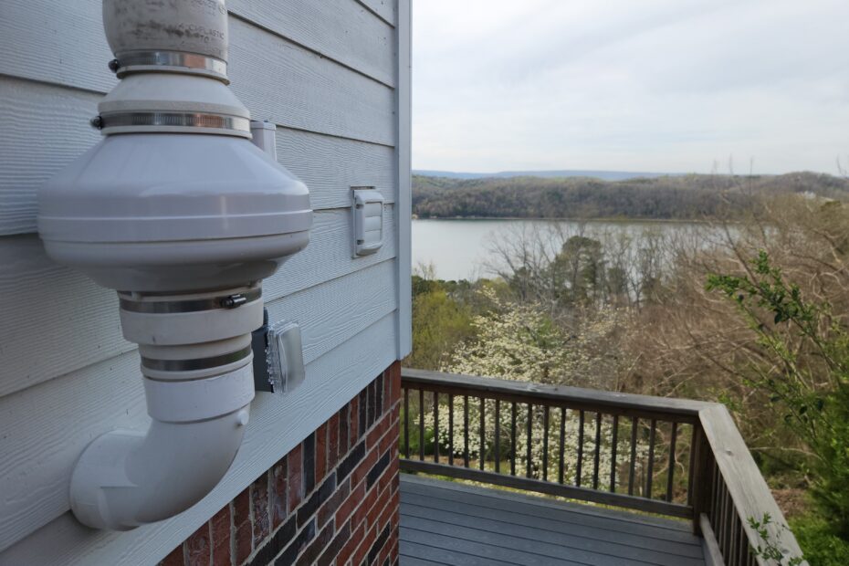 Picture depicting a radon mitigation system installed on a lakeside home.